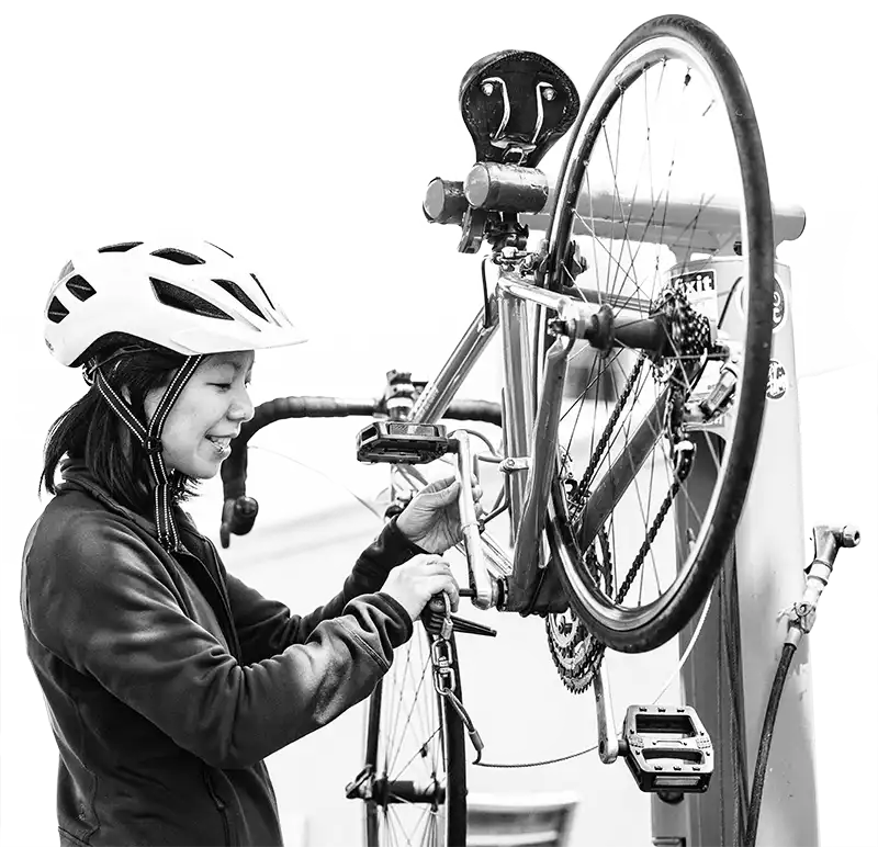 Woman fixing her bicycle on a CTBC repairi stand
