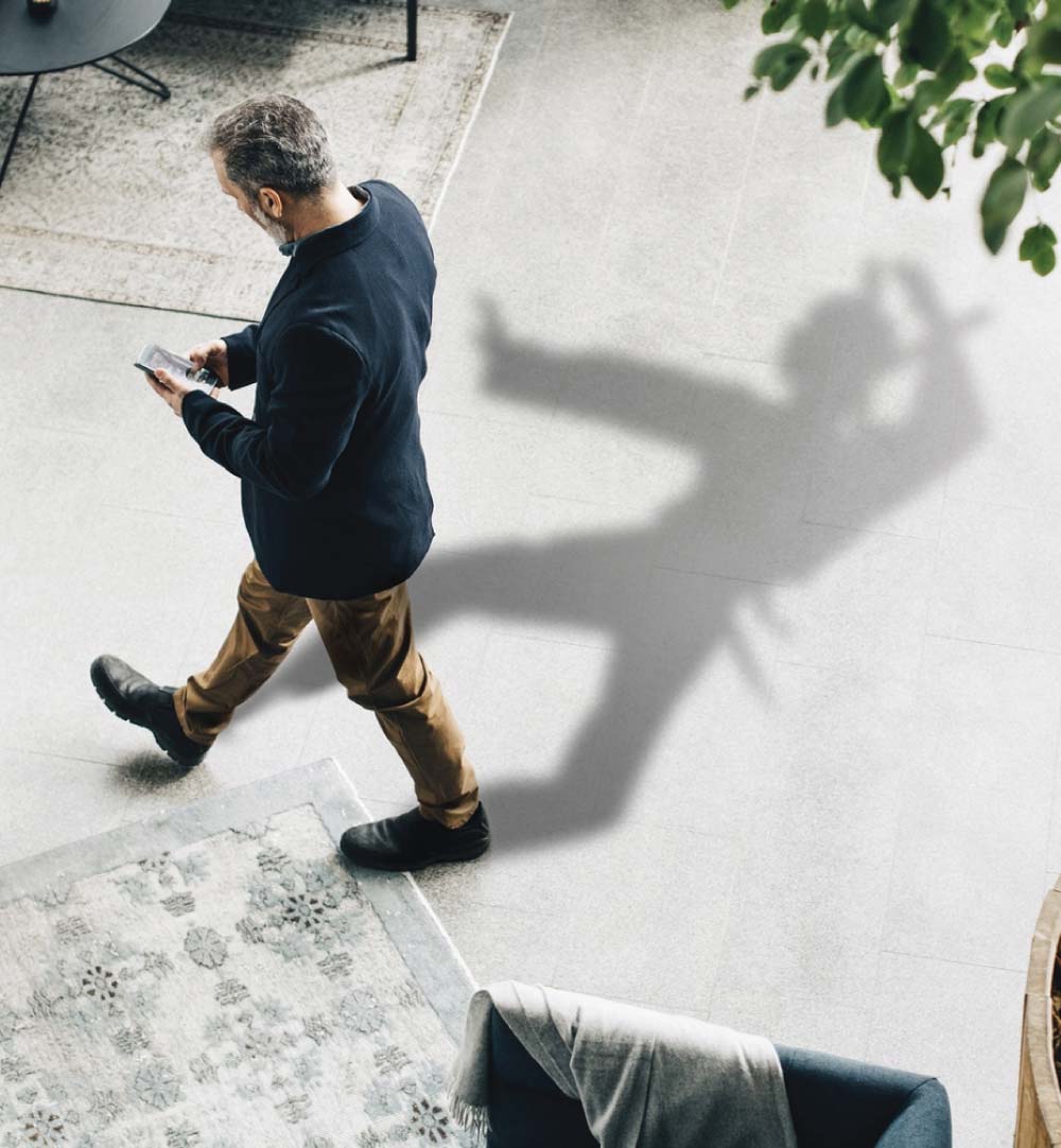 Man with iphone casting ninja shadow