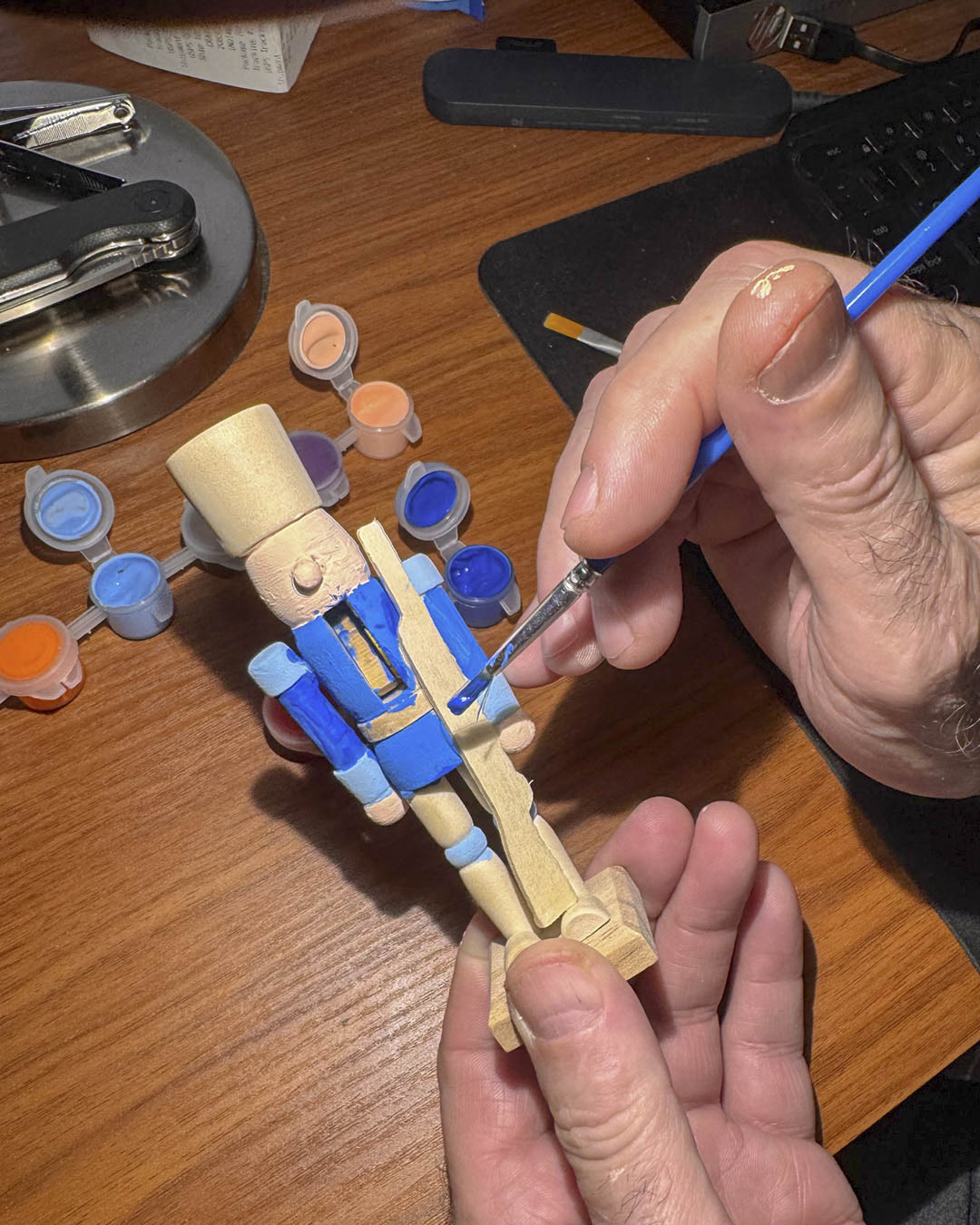Chris hand painting a nutcracker figurine